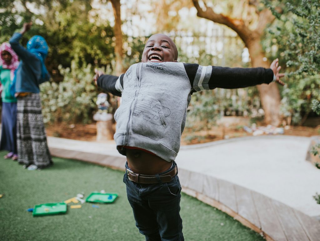 Black-boy-child-stretching-happily-during play-wk-weekly-sarah-lampert